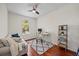 Bedroom or office with hardwood floors, neutral sofa, desk, ladder shelf and fan at 2622 W Horatio St, Tampa, FL 33609