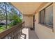 Private balcony with a wood railing, offering serene views of lush greenery at 2693 Sabal Springs Cir # 201, Clearwater, FL 33761