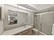 Bright bathroom with a glass-enclosed shower and a large vanity with plenty of storage at 2693 Sabal Springs Cir # 201, Clearwater, FL 33761