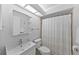 Inviting bathroom featuring a large vanity and a shower with stylish white curtain at 2693 Sabal Springs Cir # 201, Clearwater, FL 33761