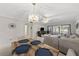 Open concept dining area flows to living room with modern chandelier at 2693 Sabal Springs Cir # 201, Clearwater, FL 33761