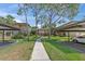 Exterior view of the property, showcasing manicured landscaping and covered parking at 2693 Sabal Springs Cir # 201, Clearwater, FL 33761