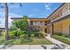 Attractive condo exterior featuring well-manicured greenery, neatly trimmed hedges, and inviting walkways at 2693 Sabal Springs Cir # 201, Clearwater, FL 33761