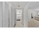 Hallway featuring ample closet space and leading to laundry area and bedroom at 2693 Sabal Springs Cir # 201, Clearwater, FL 33761