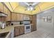 Well-lit kitchen offering a ceiling fan, oven, and a microwave at 2693 Sabal Springs Cir # 201, Clearwater, FL 33761