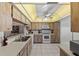 Charming kitchen with wood-grain cabinets and bright countertops at 2693 Sabal Springs Cir # 201, Clearwater, FL 33761