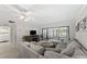 Living room showcasing comfortable seating, abundant natural light, sliding glass doors, and a convenient laundry area at 2693 Sabal Springs Cir # 201, Clearwater, FL 33761