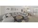 Open-concept living area featuring a comfortable sectional sofa, dining space, and plenty of natural light at 2693 Sabal Springs Cir # 201, Clearwater, FL 33761