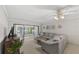 Comfortable living room with a large sectional sofa, sliding glass doors, and a ceiling fan at 2693 Sabal Springs Cir # 201, Clearwater, FL 33761