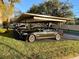 Assigned covered parking in community setting with manicured lawn and easy access at 2693 Sabal Springs Cir # 201, Clearwater, FL 33761