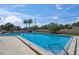 Large community pool with clear water, plenty of seating and a glimpse of blue sky at 2693 Sabal Springs Cir # 201, Clearwater, FL 33761