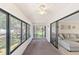 Inviting sun room featuring glass windows with sliding doors to the living room and backyard at 2693 Sabal Springs Cir # 201, Clearwater, FL 33761