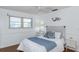 Bedroom featuring wood floors, natural light, and coastal-themed decor at 2722 Sand Hollow Ct # 2722, Clearwater, FL 33761