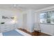 Bedroom with wood floors, dresser, chair, and natural light from a window at 2722 Sand Hollow Ct # 2722, Clearwater, FL 33761