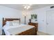 Comfortable bedroom featuring a queen bed, window and wooden dresser at 2722 Sand Hollow Ct # 2722, Clearwater, FL 33761