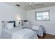 Charming bedroom with two twin beds, wainscotting and soft, natural light at 2722 Sand Hollow Ct # 2722, Clearwater, FL 33761
