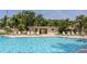 Community pool area with sun loungers and shaded seating at 2722 Sand Hollow Ct # 2722, Clearwater, FL 33761