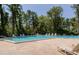 Large community swimming pool with ample seating and mature trees at 2722 Sand Hollow Ct # 2722, Clearwater, FL 33761
