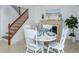 Cozy dining area featuring white table set for four, fireplace, and staircase at 2722 Sand Hollow Ct # 2722, Clearwater, FL 33761