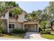 Charming two-story home with attached covered carport, tropical landscaping, and manicured lawn at 2722 Sand Hollow Ct # 2722, Clearwater, FL 33761