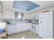 Bright kitchen featuring white cabinets, modern appliances and blue ceiling at 2722 Sand Hollow Ct # 2722, Clearwater, FL 33761