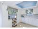Bright kitchen featuring white cabinets, tile backsplash, and view to outdoors at 2722 Sand Hollow Ct # 2722, Clearwater, FL 33761