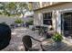 Charming brick patio featuring an outdoor dining set, BBQ, plants and privacy fence at 2722 Sand Hollow Ct # 2722, Clearwater, FL 33761