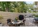 Private patio with brick pavers, a dining set, BBQ and privacy fence at 2722 Sand Hollow Ct # 2722, Clearwater, FL 33761