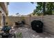 Cozy brick patio features a dining set, BBQ, potted plants, and privacy fence at 2722 Sand Hollow Ct # 2722, Clearwater, FL 33761