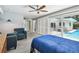 This bedroom features a sliding glass door leading to the pool and patio area at 3072 Keene Park Dr, Largo, FL 33771