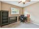 Neutral bedroom featuring a desk, shelving unit, and ceiling fan at 3072 Keene Park Dr, Largo, FL 33771