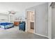 Spacious bedroom featuring neutral-colored walls, a ceiling fan, and an open doorway to a private bathroom at 3072 Keene Park Dr, Largo, FL 33771