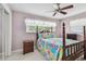 Bedroom with unique bed frame, fan, and closet at 3072 Keene Park Dr, Largo, FL 33771