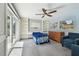 This bedroom is freshly painted and features a sliding glass door, built-in shelves and ceiling fan at 3072 Keene Park Dr, Largo, FL 33771