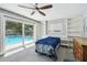 Bedroom with a sliding glass door that leads to a pool and outdoor area at 3072 Keene Park Dr, Largo, FL 33771