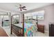 Bedroom featuring unique bed frame, ceiling fan, and mirrored closet at 3072 Keene Park Dr, Largo, FL 33771