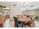 Dining area shows a round wooden table and chairs with a view into the kitchen at 3072 Keene Park Dr, Largo, FL 33771