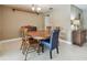 A dining room presents a round wood table with traditional chairs beneath a chandelier at 3072 Keene Park Dr, Largo, FL 33771
