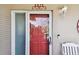 A vibrant red front door welcomes you to this charming home, complete with modern security features at 3072 Keene Park Dr, Largo, FL 33771