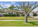 Charming single-story home with lush green lawn and mature landscaping, creating inviting curb appeal at 3072 Keene Park Dr, Largo, FL 33771