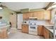 Functional kitchen equipped with a range, microwave, and stainless steel sink at 3072 Keene Park Dr, Largo, FL 33771