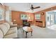 A living room with a ceiling fan and a view into the outdoor entertaining area at 3072 Keene Park Dr, Largo, FL 33771