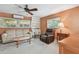 The living room has multiple windows, a ceiling fan, and built-in shelves at 3072 Keene Park Dr, Largo, FL 33771