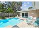 Inviting pool area with blue tiled pool, patio, and outdoor seating, perfect for relaxation and entertaining at 3072 Keene Park Dr, Largo, FL 33771