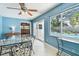 Bright sunroom with a glass table, a ceiling fan and view of the pool at 3072 Keene Park Dr, Largo, FL 33771