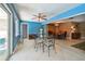 Large sunroom with an indoor glass dining table and chairs that connects to a warm dining room at 3072 Keene Park Dr, Largo, FL 33771