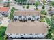 Aerial view of a modern three-story townhouse complex with well-maintained roofs and surrounding landscaping at 310 S Habana Ave # 5, Tampa, FL 33609