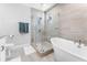Bright bathroom featuring a soaking tub, glass enclosed shower, and modern finishes at 310 S Habana Ave # 5, Tampa, FL 33609