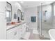 Bright bathroom featuring double vanity sinks, soaking tub, glass enclosed shower, and modern finishes at 310 S Habana Ave # 5, Tampa, FL 33609