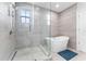 Bright bathroom featuring a soaking tub, glass enclosed shower, and modern finishes at 310 S Habana Ave # 5, Tampa, FL 33609